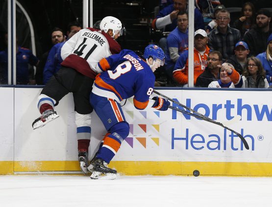 Jan 6, 2020; Brooklyn, New York, USA; New York Islanders defenseman Noah Dobson (8) and Colorado Avalanche center Pierre-Edouard Bellemare (41) battle for a loose puck during the first period at NYCB Live. Mandatory Credit: Andy Marlin-USA TODAY Sports