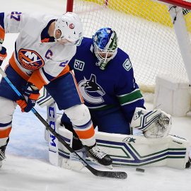 Mar 10, 2020; Vancouver, British Columbia, CAN; Vancouver Canucks goaltender Thatcher Demko (35) blocks a shot on goal by New York Islanders forward Anders Lee (27) during the third period at Rogers Arena. Mandatory Credit: Anne-Marie Sorvin-USA TODAY Sports