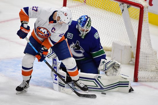 Mar 10, 2020; Vancouver, British Columbia, CAN; Vancouver Canucks goaltender Thatcher Demko (35) blocks a shot on goal by New York Islanders forward Anders Lee (27) during the third period at Rogers Arena. Mandatory Credit: Anne-Marie Sorvin-USA TODAY Sports