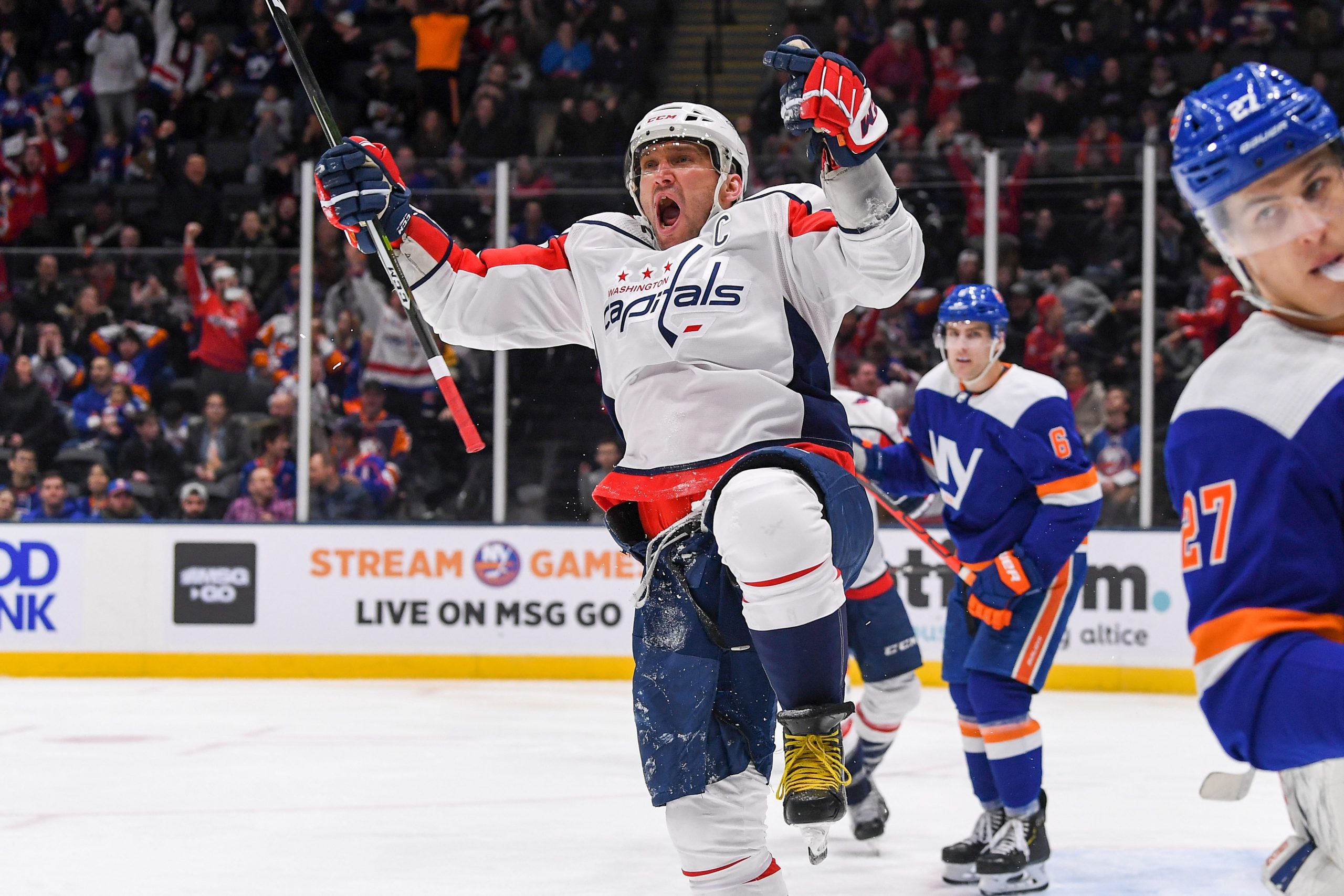 Jan 18, 2020; Uniondale, New York, USA; Washington Capitals left wing Alex Ovechkin (8) celebrate after scoring a goal against the New York Islanders during the third period at Nassau Veterans Memorial Coliseum. Mandatory Credit: Dennis Schneidler-USA TODAY Sports