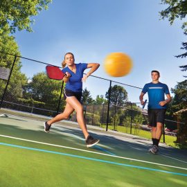 Young Man and Woman Pickleball Player Playing Pickleball in Court