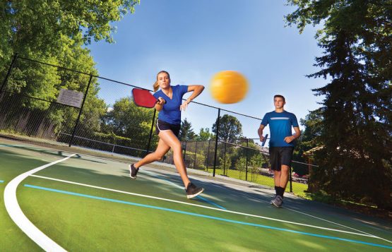 Young Man and Woman Pickleball Player Playing Pickleball in Court
