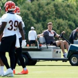 Watch a hilarious viral video of Cincinnati Bengals quarterback Joe Burrow driving a cart while his teammates run after practice.