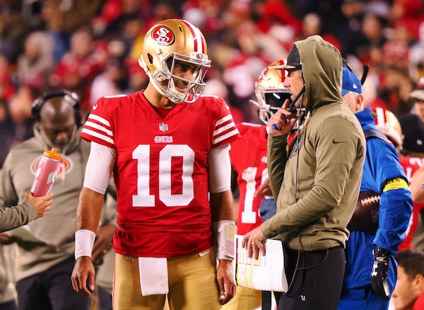Jimmy Garoppolo speaks with Kyle Shanahan on the sideline.