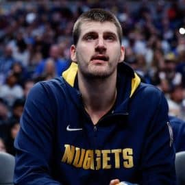 Denver Nuggets center Nikola Jokic sits and stares.