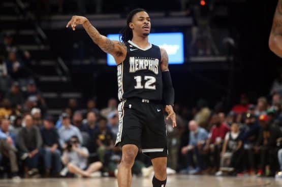 Grizzlies star Ja Morant holds his hand in the air.