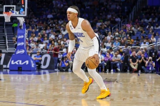 Orlando Magic forward Paolo Banchero dribbles a ball.