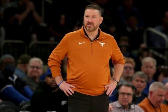 Texas Longhorns head coach Chris Beard stands with hands on hip.