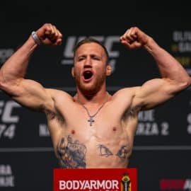 UFC fighter Justin Gaethje poses and flexes.