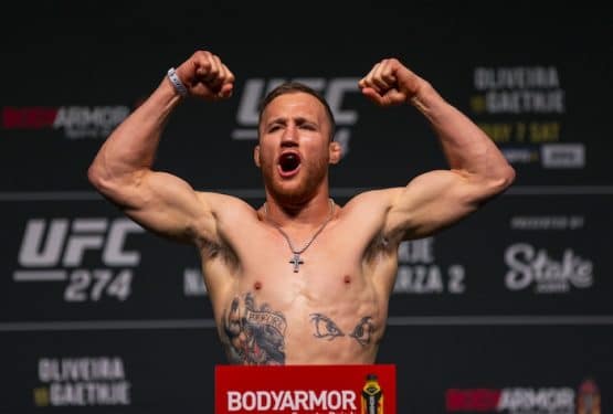 UFC fighter Justin Gaethje poses and flexes.
