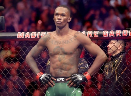 Israel Adesanya stands in the octagon.