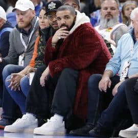 Rapper, singer and actor Drake sits courtside.