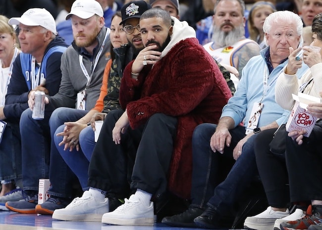Rapper, singer and actor Drake sits courtside.