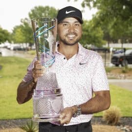 Jason Day poses with the winner's trophy.