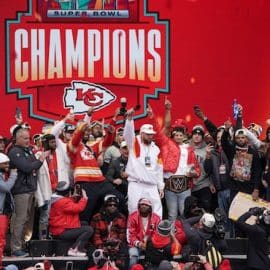 Chiefs players stand on the stage and celebrate.