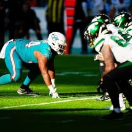 A Miami Dolphins defender lines ip against the New York Jets offensive line.