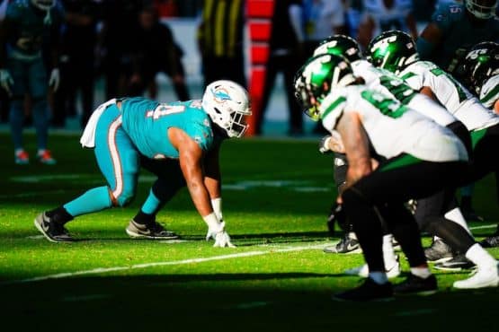A Miami Dolphins defender lines ip against the New York Jets offensive line.
