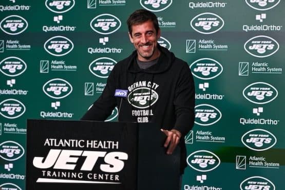 New York Jets quarterback Aaron Rodgers stands at the podium.