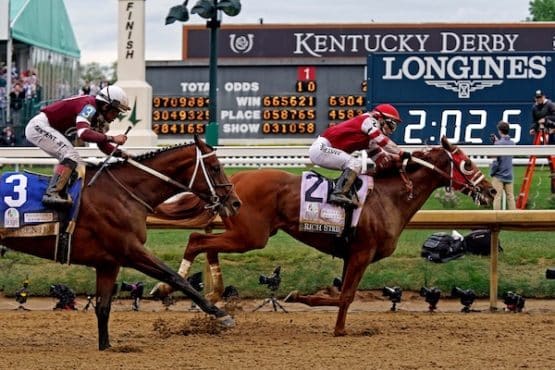Sonny Leon aboard Rich Strike wins the 148th running of the Kentucky Derby at the finish line.