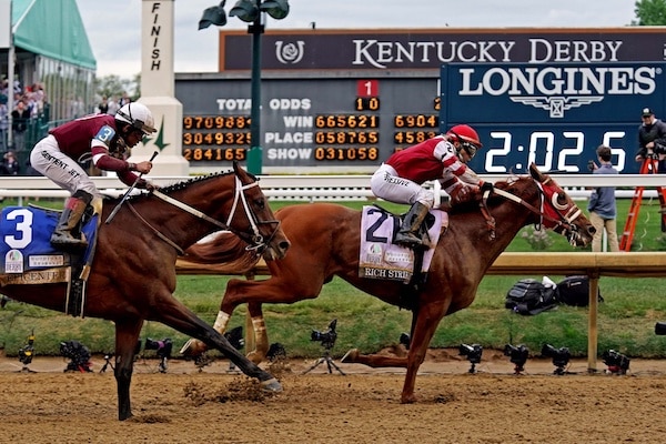 Sonny Leon aboard Rich Strike wins the 148th running of the Kentucky Derby at the finish line.