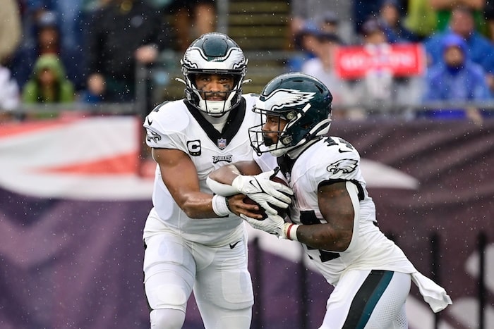 Philadelphia Eagles quarterback Jalen Hurts (1) hands the ball to running back Kenneth Gainwell