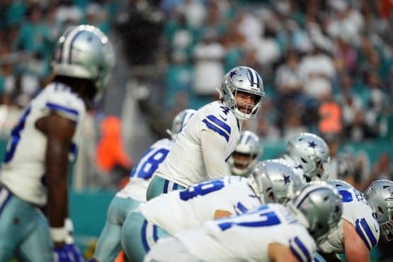 Dallas Cowboys quarterback Dak Prescott (4) looks over the offensive line