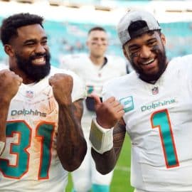 Miami Dolphins quarterback Tua Tagovailoa (1) and running back Raheem Mostert (31)