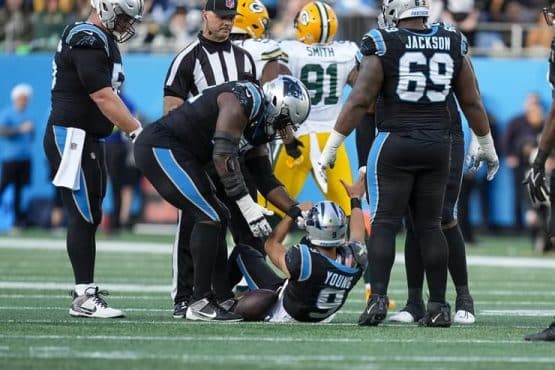 panthers moton helps up young after sack (1)